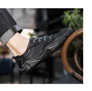 Detailed side view of black men's leather casual shoe featuring hand-sewn stitching details