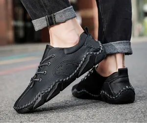 Detailed macro shot of men's black leather casual shoes with unique hand-stitched edges