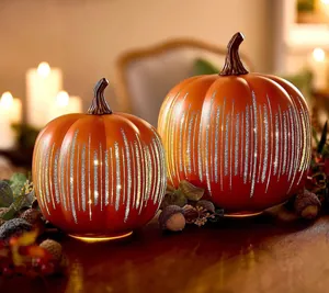 Two orange glass pumpkin LED lights with starry night patterns for Halloween decor