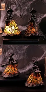 Detailed view of Halloween witch resin lamp with spooky spider web skirt patterns.