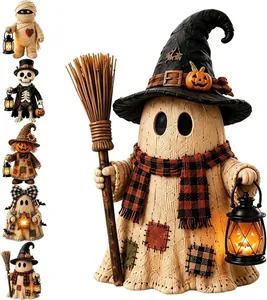 Detail of Halloween ghost figurine with witch hat and light-up lantern decoration.
