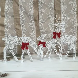 Set of three elegant white metal Christmas reindeer ornaments with red velvet bows