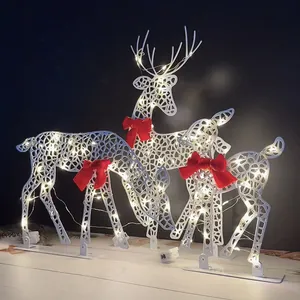 Glowing metal reindeer set with LED lights and red bows for Christmas tabletop decor