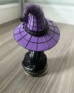 Detailed rear view of a resin Halloween witch hat cat ornament with web pattern.