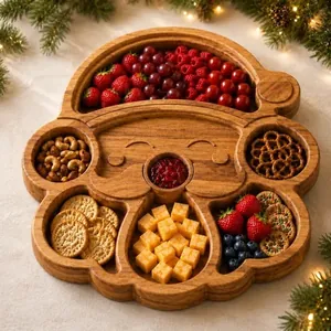 Close-up of Santa Claus shaped wooden divided tray filled with festive snacks and fruit