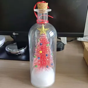 Mini red Christmas tree in a glass bottle with cork stopper and red ribbon decor