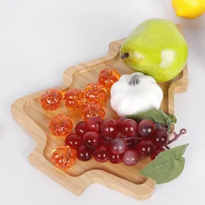 Macro detail of a natural wooden Christmas tree shaped tray featuring colorful artificial fruits