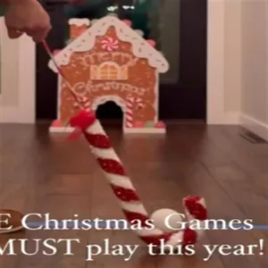Action shot of the gingerbread golf game set with candy cane club and house target