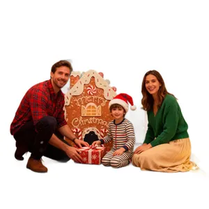 Gingerbread house golf game set with family enjoying Christmas holiday fun at home.