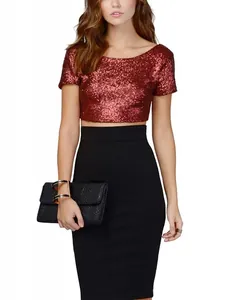 Elegant woman in a shimmering red sequin crop top and a high-waisted black pencil skirt