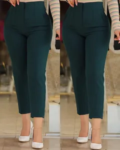 Detail view of slim fit dark green cropped dress pants with a high waist and pleated front.
