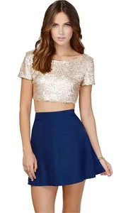 Sexy gold sequin crop top for women paired with a navy blue skirt on white background