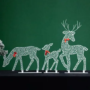 Set of three white metal Christmas reindeer with red bows for holiday desktop decoration