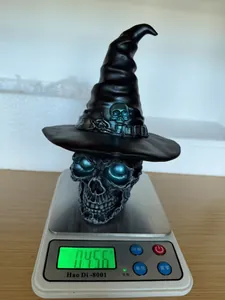 Detail view showing weight of the Gothic Halloween resin skull witch hat night light