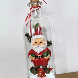 Decorative glass bottle with a cute Santa Claus figurine and Christmas tree decor