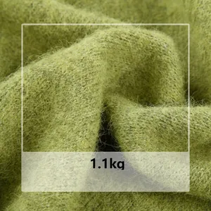 Detailed macro view of soft green wool blend knit fabric texture with 1.1kg weight