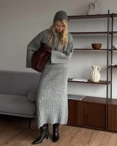 Detail showing a full outfit of a grey ribbed knit sweater and matching maxi skirt