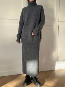 Full-length view of a gray wool-blend knitted sweater and matching midi skirt set.