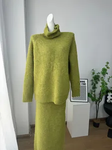 Detailed view of olive green wool blend knit set with turtleneck sweater and skirt.