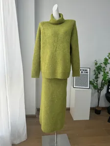 Two-piece olive green wool blend knit set with turtleneck sweater and matching skirt.