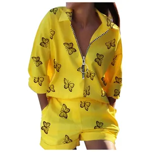 Close-up of vibrant yellow butterfly print two-piece set with a functional front zipper