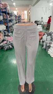 High-waisted straight leg trousers with decorative button details in a soft gray fabric.