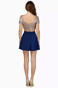 Rear view of a shimmering gold sequin crop top showing the U-shaped back design.