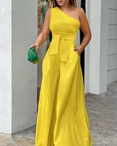 Elegant women's yellow one-shoulder wide-leg jumpsuit with tie waist and pockets