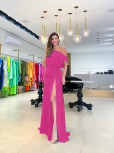 Elegant fuchsia one-shoulder floor-length evening dress with high side slit for formal parties