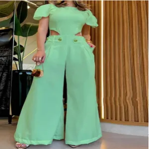 Detailed shot of trendy mint green jumpsuit featuring waist cutouts and wide leg fit