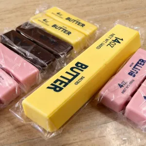 Detailed view of realistic butter stick slow-rebound squeeze toys in various colors.