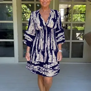 Elegant V-neck printed midi dress with smocked waist and bell sleeves for women