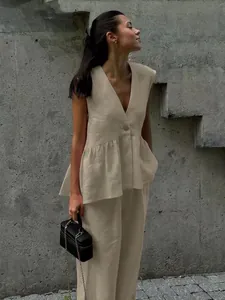 Modern chic beige linen sleeveless vest and wide-leg trousers set in an urban setting