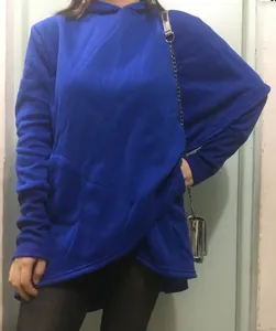 Detail view of women's bright blue long-sleeve hooded sweatshirt with a unique asymmetrical hem design