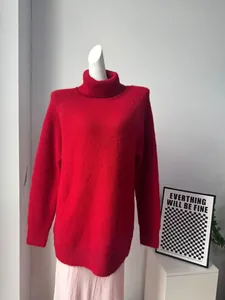 Cozy and vibrant red wool blend turtleneck sweater for women featuring a loose fit design