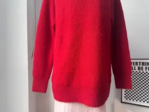 Close-up of a vibrant red oversized wool blend knit sweater showing soft plush texture