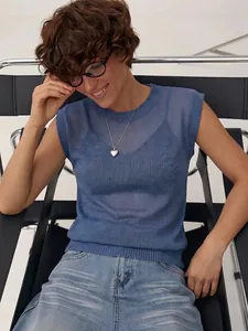 Detail view of a blue sheer knit sleeveless vest for women on a model in studio