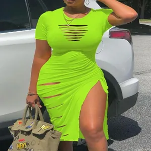 Close-up of neon green bodycon dress featuring chest cut-outs and a high leg slit