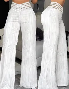 Close-up detail of white high-waisted wide-leg trousers with wavy pleated texture.
