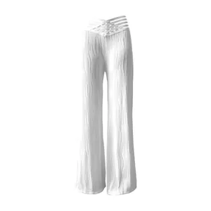 White high-waist pleated wide-leg trousers with unique water ripple texture detail.