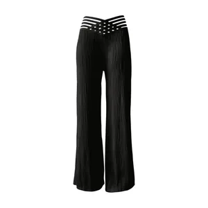 Close-up detail of black high waisted pleated wide leg trousers with hollow out waist design