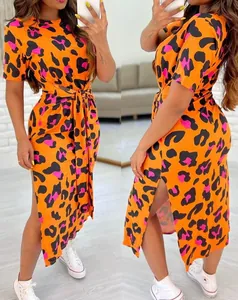Detailed view of the vibrant orange leopard print dress with side slit and tie waist