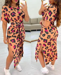 Detailed view of the vibrant leopard print and side slit on the tie-waist dress.