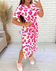 Close-up detail of a pink leopard print midi dress with side slit and waist tie.