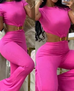 Macro detail of sexy hot pink ribbed jumpsuit featuring waist cut-out and gold ring accent