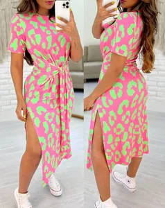 Detailed view of neon pink leopard print dress with side slit and waist tie detail.