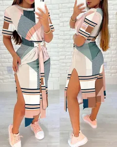 Side view of short-sleeved geometric print dress with high slit and waist tie detail