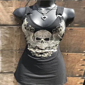 Close-up of black sleeveless tank top featuring a winged skull print and metal rings.