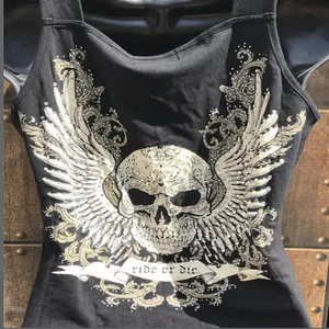 Close-up detail of gothic skull and wings graphic print on black sleeveless cotton tank top.