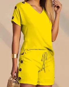 Detailed view of yellow V-neck top and shorts two-piece set with button accents